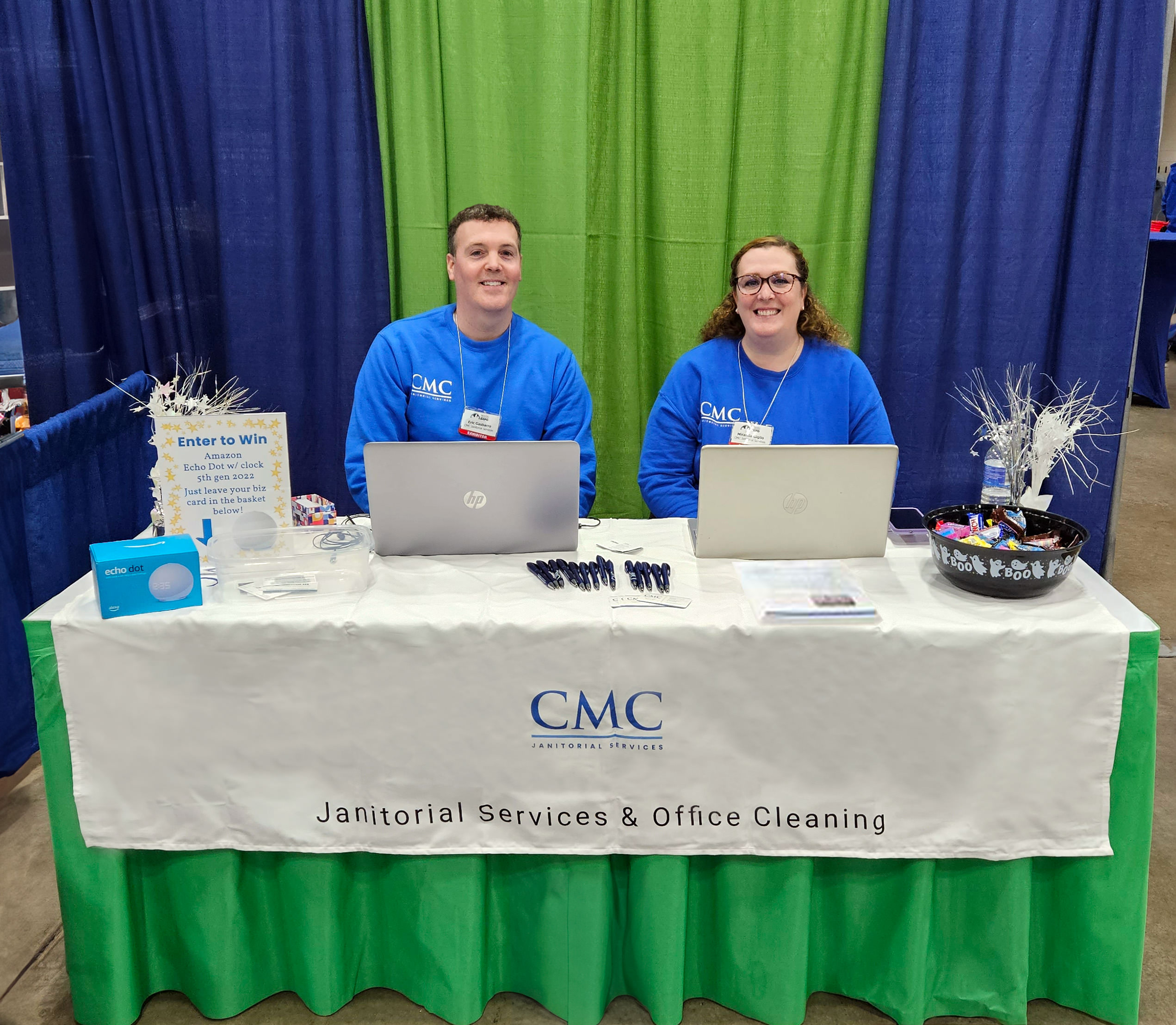 2 smiling custom maid owners at 2023 buffalo facility management expo booth 