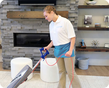 cleaner vacuuming a living room